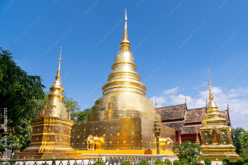 Fototapeta premium Chapel and golden pagoda at Wat Phra Singh Woramahawihan, famous travel destination in Chiang Mai, Thailand