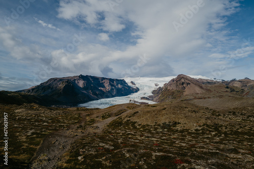 Man standing next to the Svinafellsjokull glacier in Iceland
