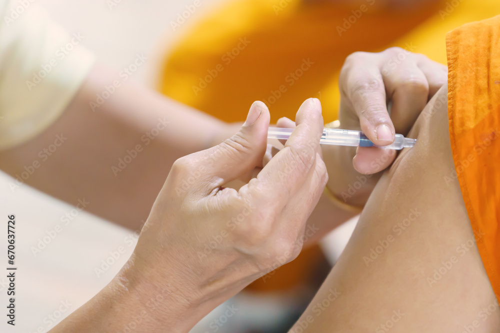 Nurse holding a syringe for the injection giving patient vaccine in hospital. Health care Concept - obrazy, fototapety, plakaty 