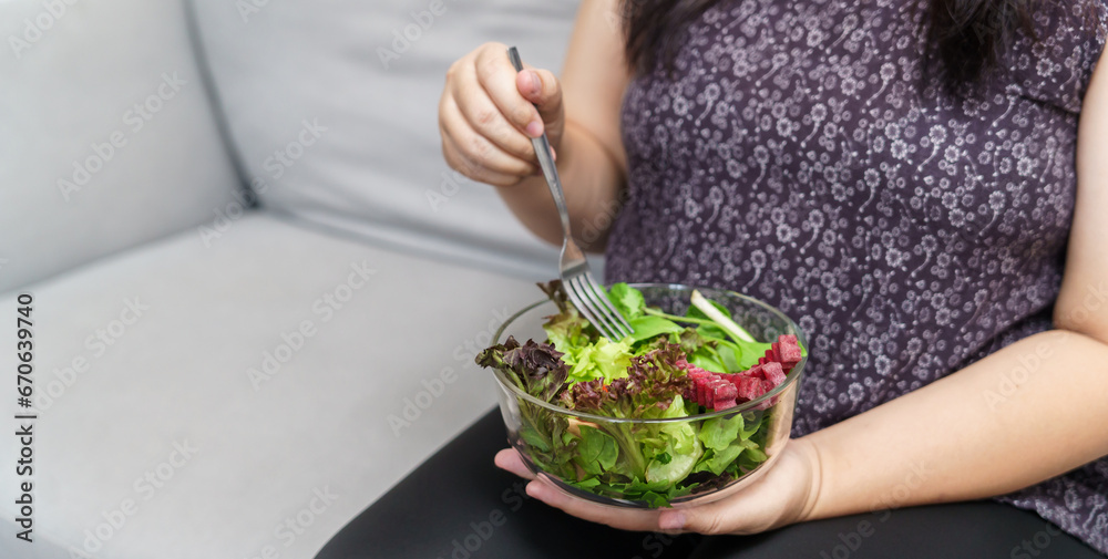 Asian Overweight woman dieting Weight loss eating fresh fresh homemade salad healthy eating concept Obese Woman with weight diet lifestyle.
