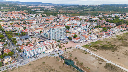 Aerial drone photo of the coastline and town centre of Comarruga in Spain