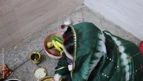 indian women doing holy rituals at home for children's wellbeing from different angle photo