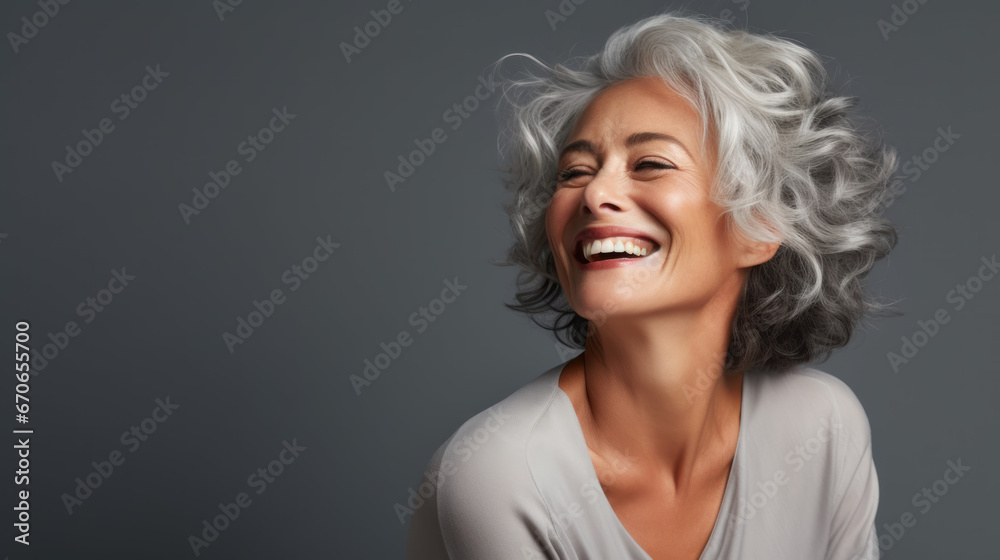 a mature lady with nice and soft skin smiling with healthy and white teeth