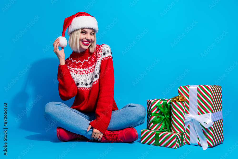 Obraz premium Full length photo of dreamy shiny lady santa helper dressed ornament sweater preparing xmas gifts isolated blue color background