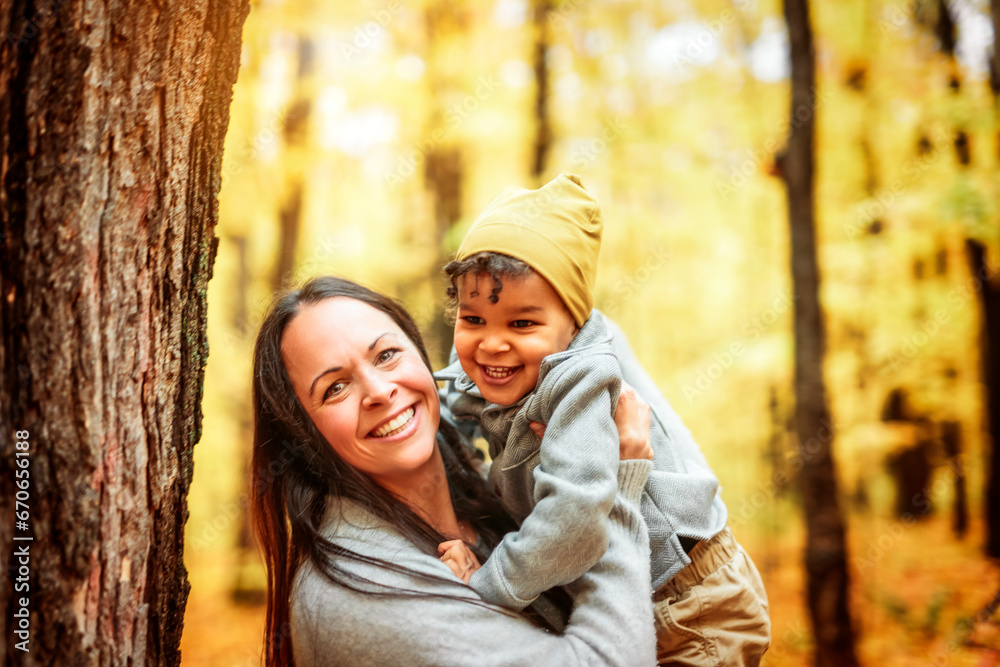 mother and son having fun in autumn park mother and son having fun in autumn park