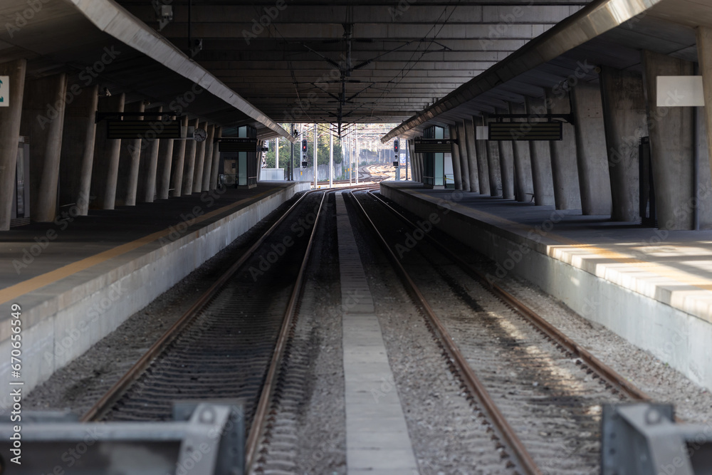 An empty subway track in a station.