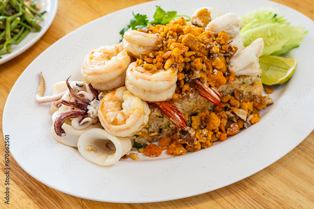 Delicious seafood thai fried rice (crab meat, shrimp, crab roe and squid)