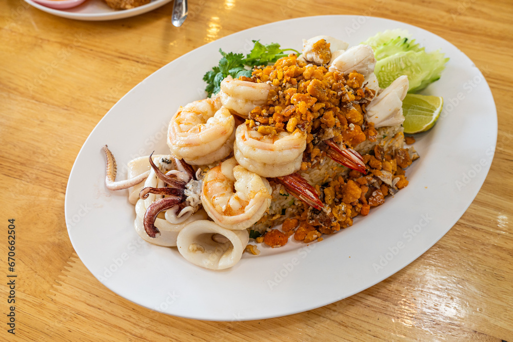 Delicious seafood thai fried rice (crab meat, shrimp, crab roe and squid)