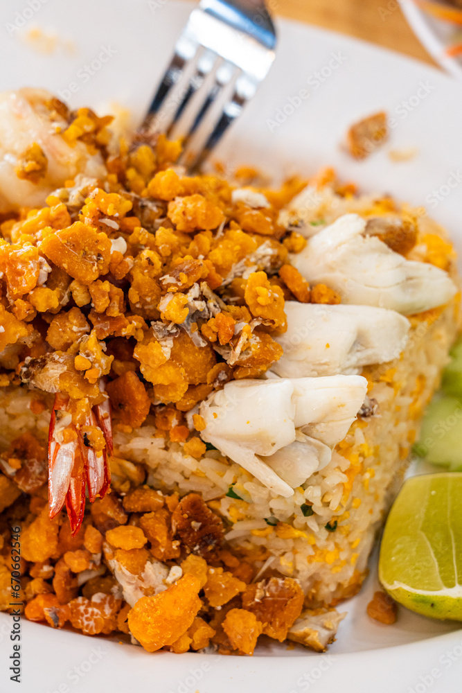Delicious seafood thai fried rice (crab meat, shrimp, crab roe and squid) closeup