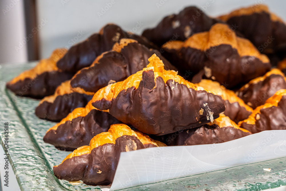 Closeup chocolate croissant on glass plate