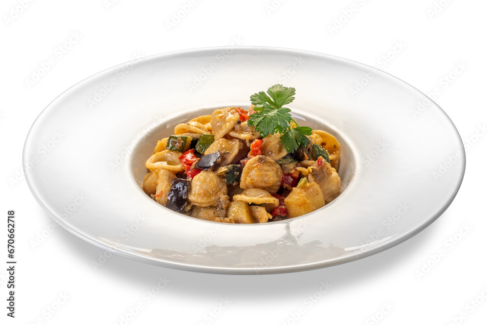 Orecchiette pasta cooked topped with eggplant and zucchini and tomato sauce and with parsley leaves in white plate isolated Orecchiette pasta cooked topped with eggplant and zucchini and tomato sauce and with parsley leaves in white plate isolated