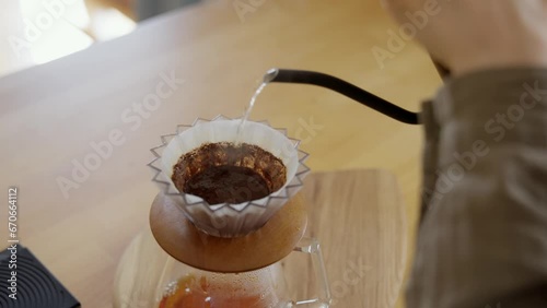 Process of brewing pour over coffee with V60 decanter. Extremely close-up shot of the finished hot beverage dripping into the dispensing container