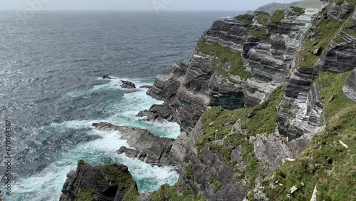 Scenic view of famous Kerry cliffs (Aillte Chiarrai). Irish coastal nature. Motion of big Atlantic ocean waves. Kerry Cliffs viewpoint, Kerry, Ireland photo