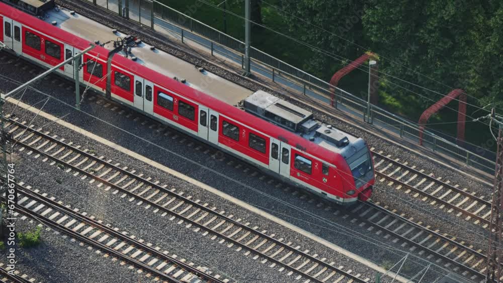S-Bahn regional suburban speed train drive in Cologne at Hohenzollern bridge in Germany, aerial shot