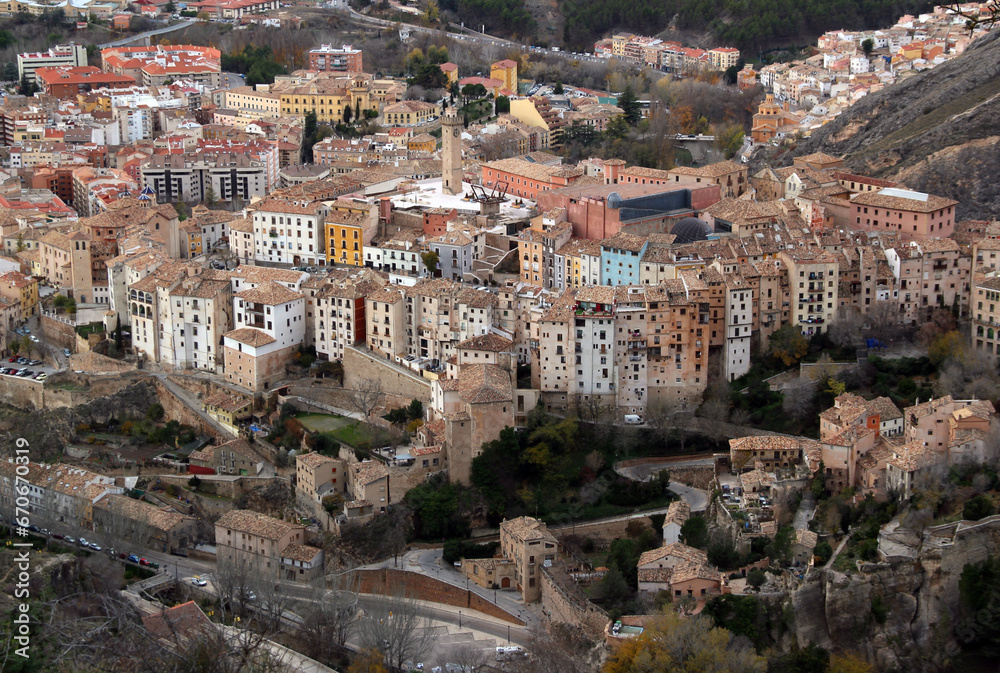 Aerial view of the historic city center of Cuenca with colorful houses, Torre de Mangana tower and surrounding walls near Madrid, Spain