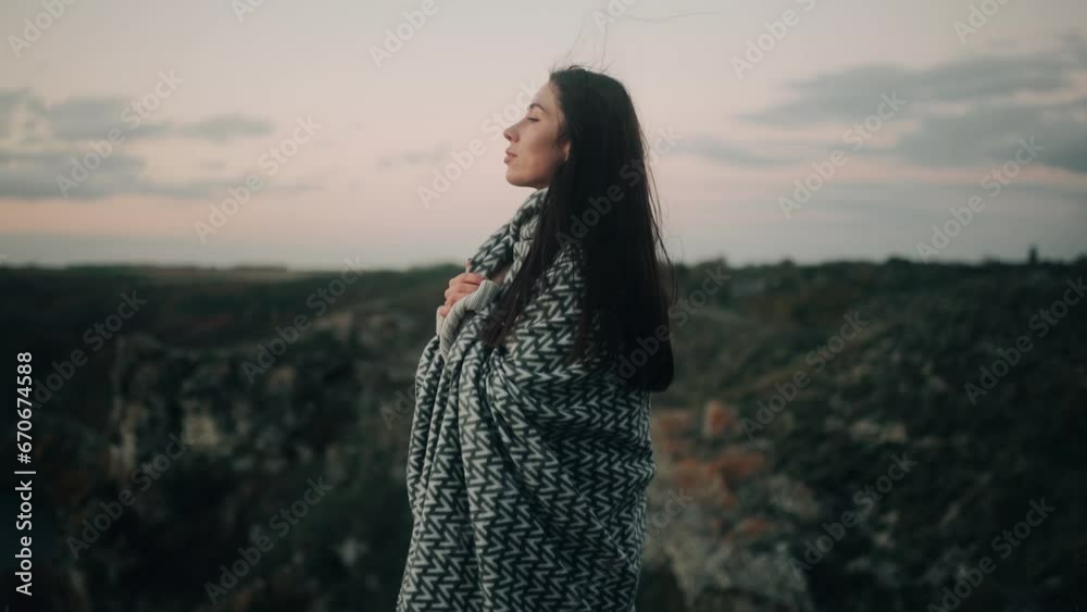 Charming lady with flying long dark hair looking at the mountains enjoying beautiful nature Inspired young woman looking at the sky outdoors Charming lady with flying long dark hair looking at the mountains enjoying beautiful nature Inspired young woman looking at the sky outdoors