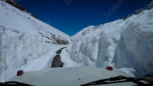 Snow-Blanketed Mountains Along a Narrow Snow Covered Road in Shinkula Pass photo