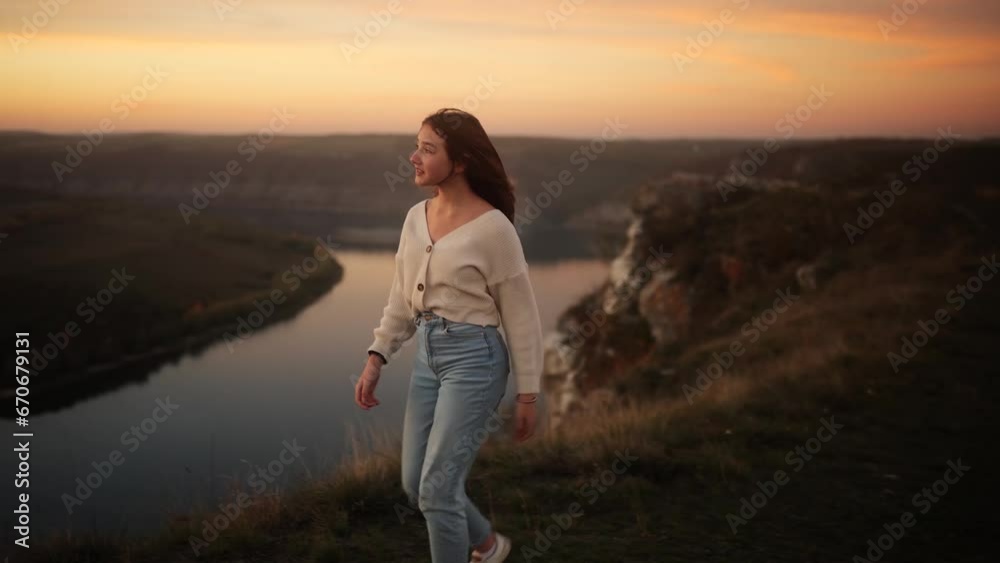 Little girl walking in the mountains looking around with incredible pink sunset Happy teenager feeling absolutely free and satisfied outdoors Little girl walking in the mountains looking around with incredible pink sunset Happy teenager feeling absolutely free and satisfied outdoors