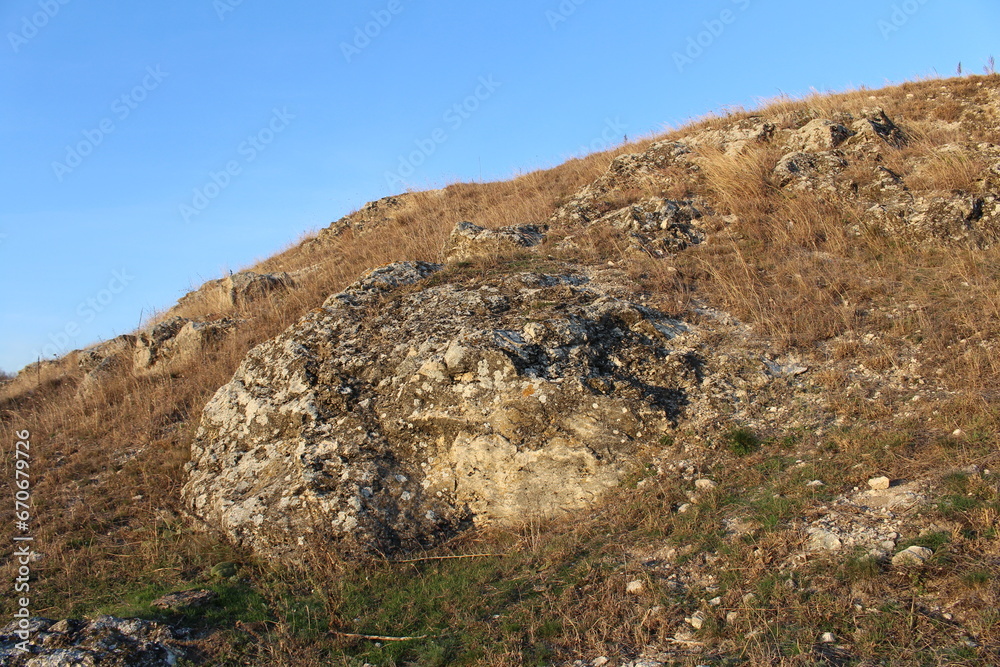 A rocky hill with a dirt path