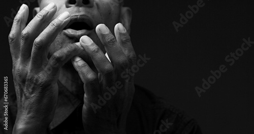 man praying to God with the bible on black background with people stock image stock photo photo