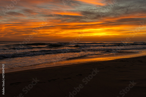 Beautiful yellow sunrise on the beach at Miramar, Spain