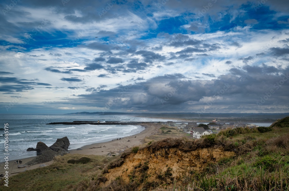 Vibrant beach landscape featuring an overcast sky, a tranquil body of water