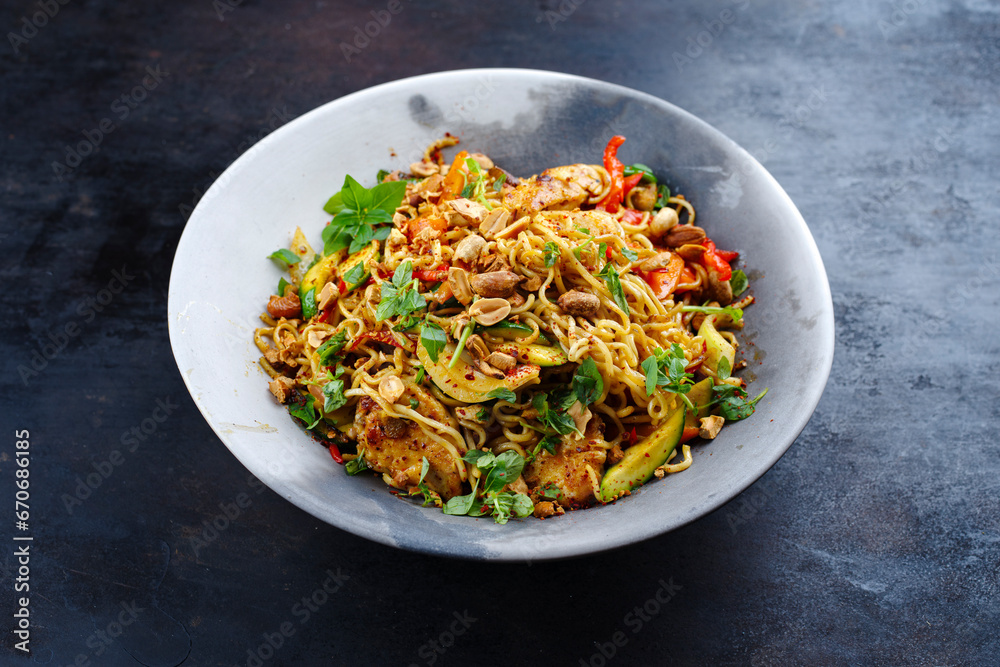 Traditional Thai Pad Mama with Instand noodles, chicken and vegetable served as a close-up on a design plate with text space Traditional Thai Pad Mama with Instand noodles, chicken and vegetable served as a close-up on a design plate with text space