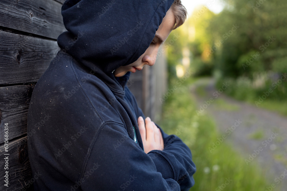 Fototapeta premium teenage boy walking in the village in summer