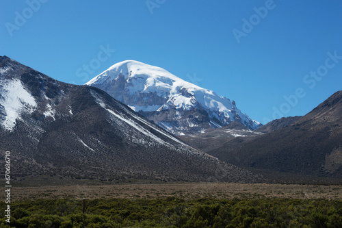 Sajama volcano in Bolivia behind lower mountains