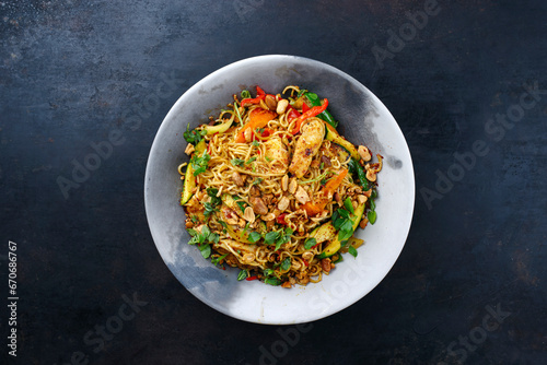 Traditional Thai Pad Mama with Instand noodles, chicken and vegetable served as top view on a design plate with text space
