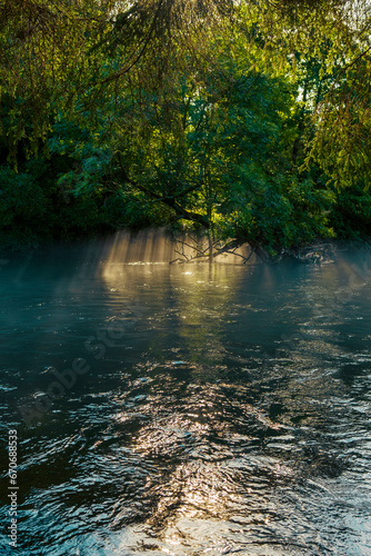 Fog and sun rays on the river in the morning. Water and light games. A morning view from the Eifel national park. Misty river view. Heartbreaking and dreamy nature landscapes. Eifel  Germany