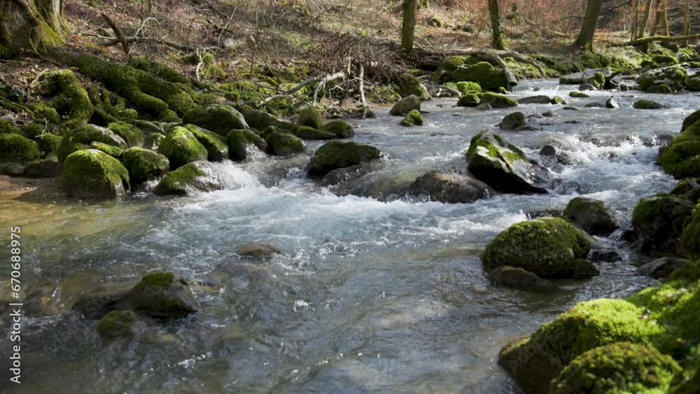 Beautiful sunny forest river with mossy rocks in slow motion. Beautiful sunny forest river with mossy rocks in slow motion.