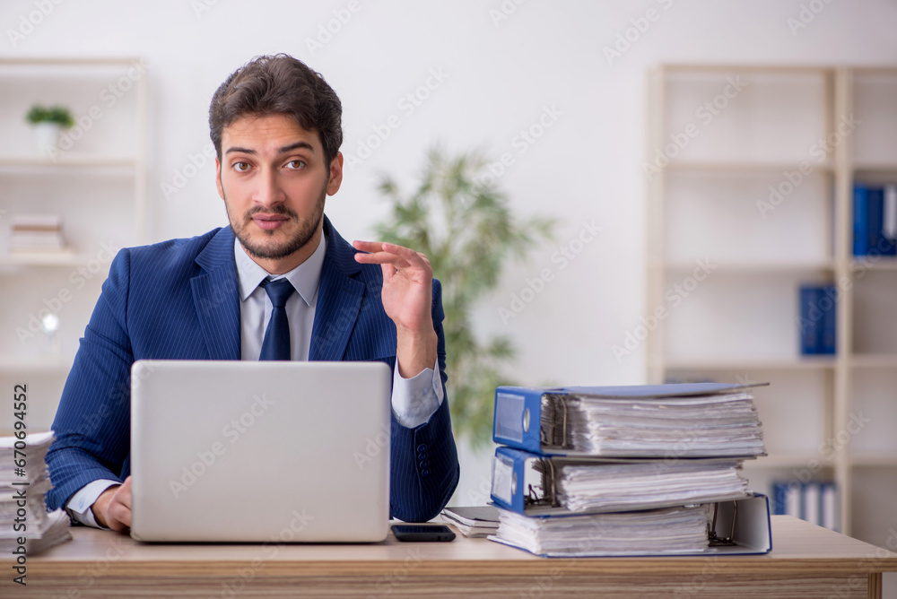 Young male employee working in the office Young male employee working in the office