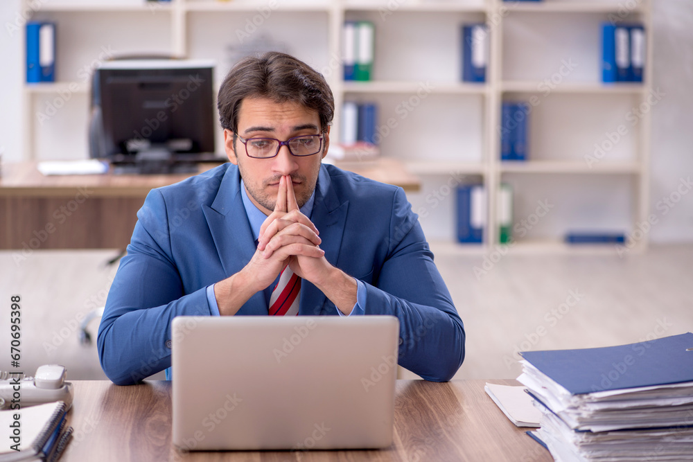 Young male employee working in the office Young male employee working in the office