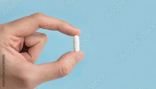 Close-up photo of a hand holding a pill. Generative AI