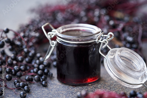 Black elderberry syrup in a glass jar