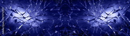 Cracked glas, shards of broken glas on blue background, abstract texture design  photo