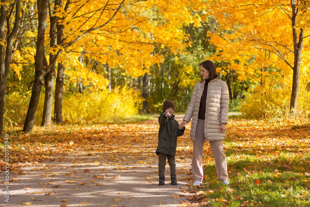 Fototapeta premium Mom and son in the autumn park.