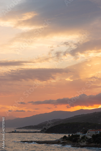 View to the slopes and costline of wetsern Ikaria with dramatic sky.