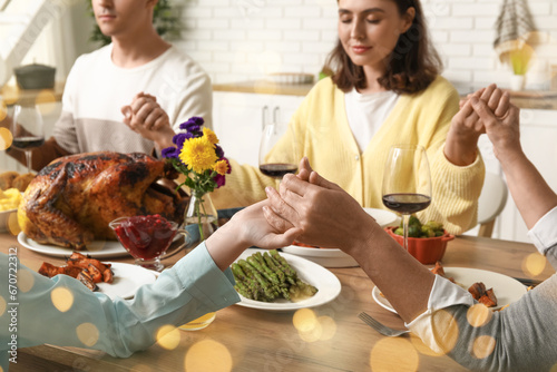 Happy family praying before...