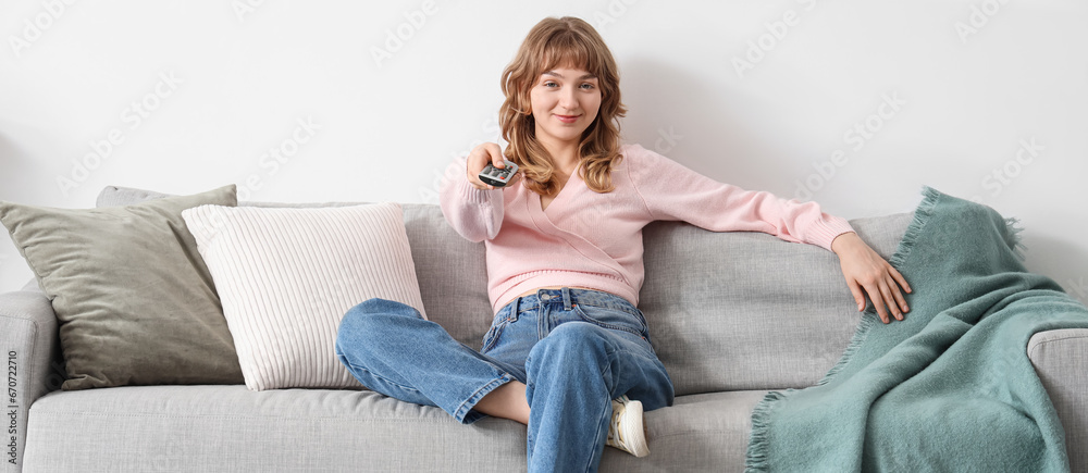 Young woman watching movie on sofa at home Young woman watching movie on sofa at home
