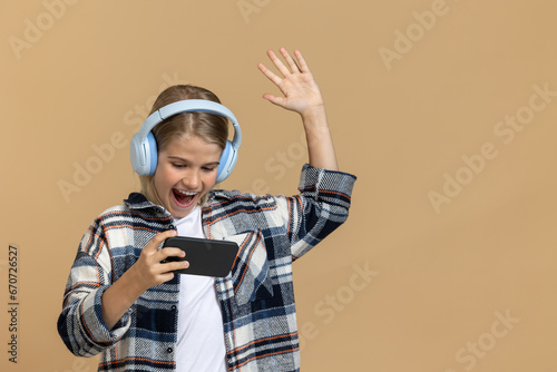 Teen in headphones with a smartphone in hands