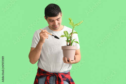 Young man with shovel and p...