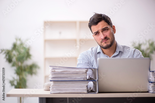 Young male employee working in the office