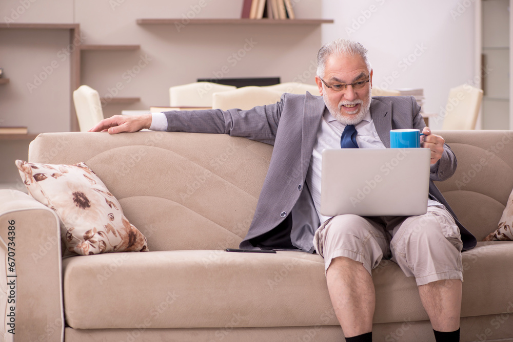 Old male employee working from home during pandemic Old male employee working from home during pandemic
