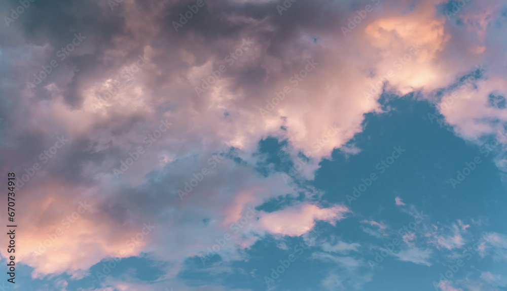 Scenic rose golden glowing big cloud highlighted by Sunset. Close up panoramic aerial photo of deep blue sky with puffy clouds Scenic rose golden glowing big cloud highlighted by Sunset. Close up panoramic aerial photo of deep blue sky with puffy clouds