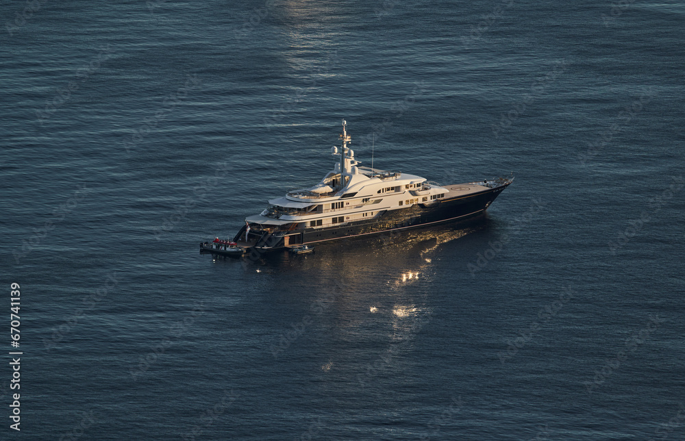 Obraz premium Monaco, lonely mega yacht in sea at sunset, huge motor boat, wealth life of billionaires 