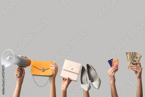 Female hands with stylish women accessories, credit cards and money on grey background. Black Friday sale
