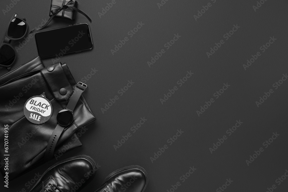 Composition with gadgets, stylish female clothes and shoes on dark background. Black Friday sale