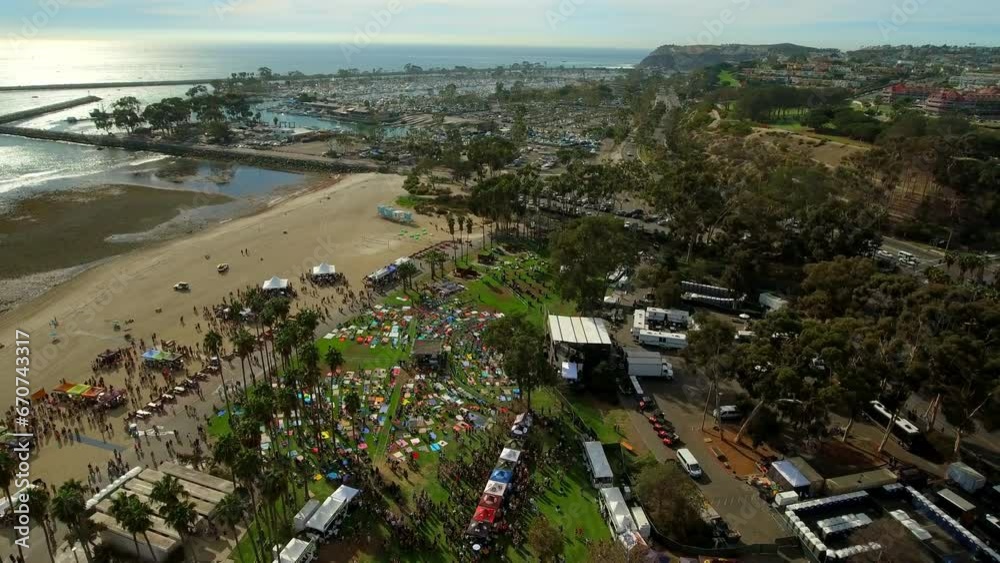 Aerial Panning Shot Of People At Beach Park Event Near Sea Against Sky - Dana Point, California Aerial Panning Shot Of People At Beach Park Event Near Sea Against Sky - Dana Point, California